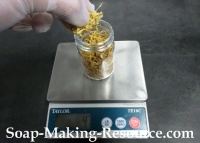 Measuring Calendula Petals into Mason Jar